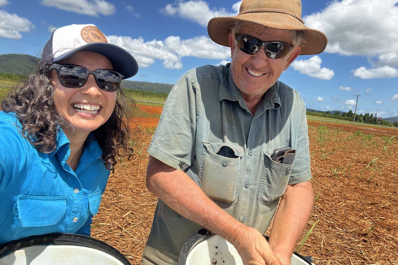 Maria Solis with a cane grower in the field